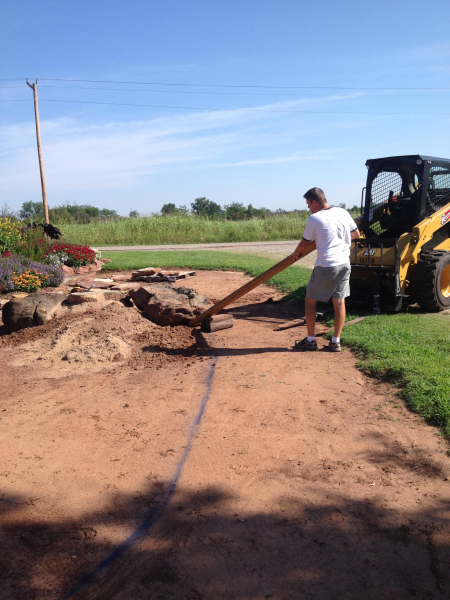 Using a wooden lever to shift rocks into place. Using a wooden lever to shift rocks into place.